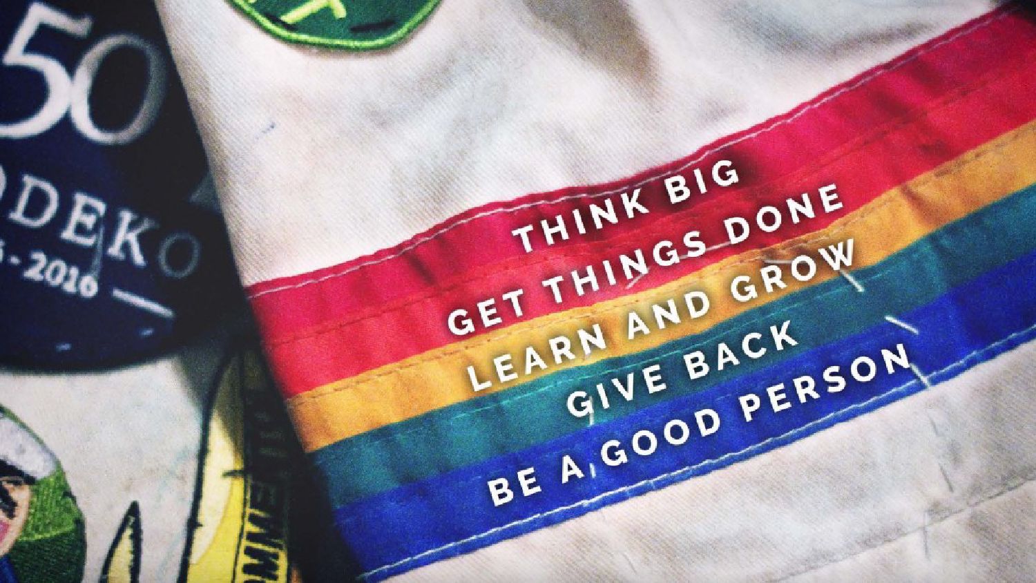 Prodeko's values on an overalls patch over the rainbow stripe